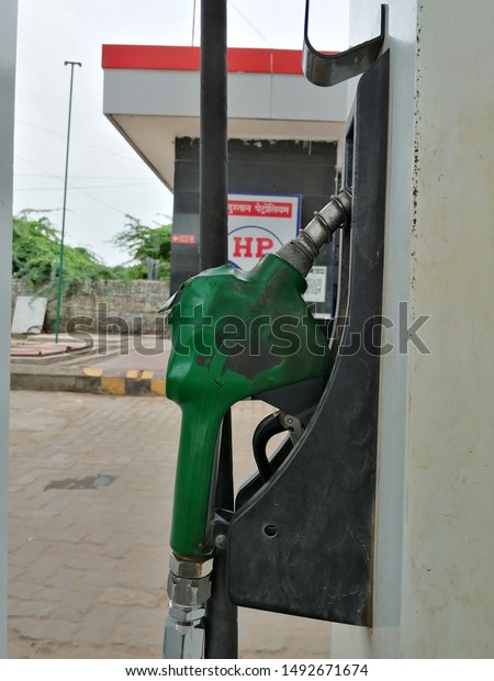 Kalol, Gujarat, India - August 31, 2019: Close up of a\
petrol filling nozzle with the logo of HP in the background.\
Hindustan Petroleum is one of the leading oil and natural gas\
companies in India. 