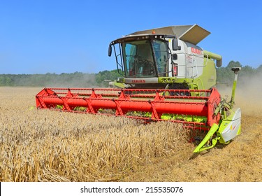 Kalush, Ukraine - AUGUST 11: Modern John Deere combine harvesting grain in the field near the town Kalush, Western Ukraine August 11, 2014 - Shutterstock ID 215535076