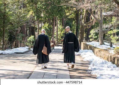 Kamakura, Japan - February 21, 2014 - Two Monks Walking Inside The Engaku Ji Sacred Complex, Kamakura, Japan