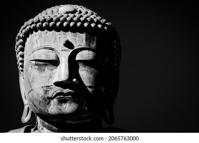 Kamakura, Kanagawa Prefecture, Japan - October 23, 2021: The face of the Great Buddha, or Kamakura Daibutsu, the 43 foot tall and 103 ton statue which was completed in 1252.