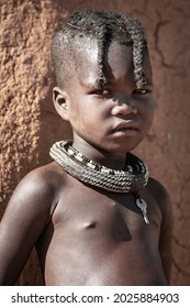 Kamanjab, Namibia- June 21, 2021: Portrait Of A Child From The Himba Tribe In Namibia. Himbas Are An African Tribe From North Namibia And South Angola.