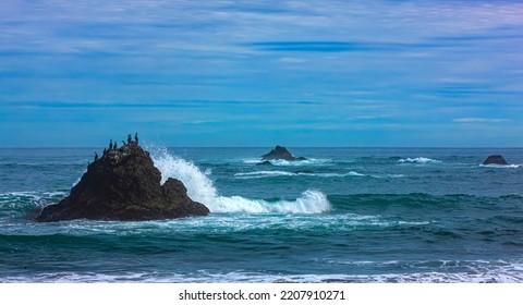 Kamchatka Peninsula, Pacific Ocean, Waves And Rocks. Selective Focus