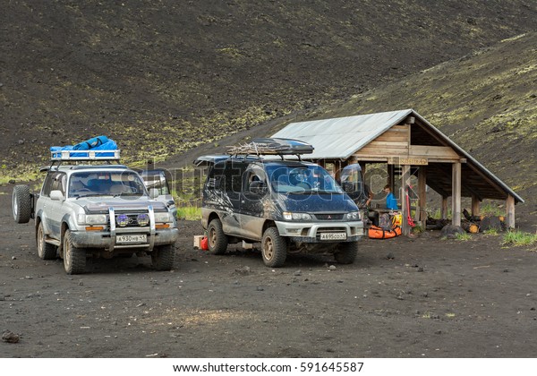 Kamchatka Peninsula, Russia - August 20, 2016: Cars\
SUVs in the parking lot for tourists. North Breakthrough Great\
Tolbachik Fissure Eruption\
1975
