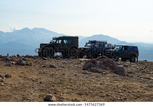 KAMCHATKA PENINSULA,\
RUSSIAN FAR EAST - JULY 4, 2019: Off-road cars near Mutnovsky\
volcano, Kamchatka.