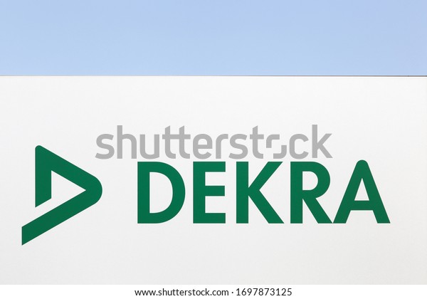 Dekra logo on a wall. Dekra is a vehicle inspection company founded in Berlin, Germany in 1925. Dekra is the third largest inspection company in the world