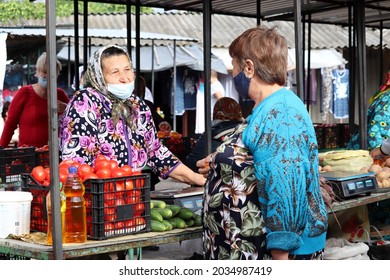 Kamenka, Pridnestrovie - September 2021: Woman Buys Vegetables On Farm Market In Eastern Europe. People In Mask, Safety During Coronavirus Pandemic