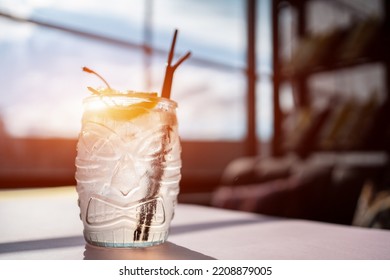 kamikaze cocktail in tiki glass with vodka, triple sec, lemon and cherry