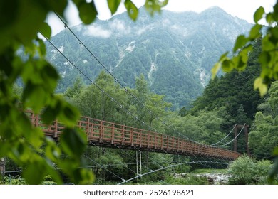 Kamikochi is a popular destination for hiking and enjoying the serene, pristine beauty of nature. One of its main attractions is the Kappa Bridge, an iconic wooden bridge that spans the Azusa River. - Powered by Shutterstock