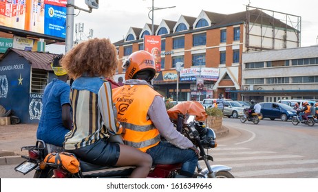 KAMPALA, UGANDA - JANUARY 05, 2020: An African SafeBoda Driver With His Female Passenger. SafeBoda Is An Uber-style Mobile App For Motorcycle And Taxi In East Africa, Very Popular For Local Users.