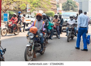 KAMPALA, UGANDA - JANUARY 14 2020: Unidentified people drive their motorcycles down a street in Kampala, Uganda. Motorcycles are widely used in Kampala and Uganda as main kind of transportation.