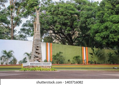 Kampala, Uganda - January 21, 2015: Monument Of Independence. A Woman With Tied Legs Holding A Baby In Her Arms.