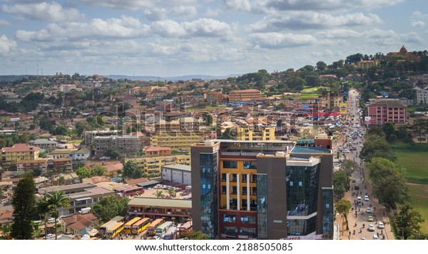 Kampala, Uganda - May 20, 2022: Busy street\
and houses in Kampala in June, aerial\
view