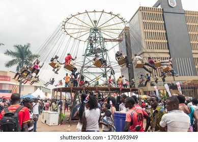 Kampala / Uganda - October 4, 2016: Children In Carousel Raised Above The Ground Spinning During Kampala Festival