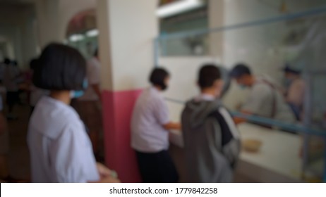 Kampeangpet,Thailand-July 17,2020 :Thai Students Wearing Face Masks And Stand In Line With A Social Distance To Buy Food In The School Cafeteria To Prevent The Outbreak Of The Coronavirus (Covid 19)  