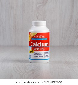 Kamyanets-Podilskyi, Ukraine - November 04, 2019: 21st Century, Calcium 500 + D3, 400 Tablets.  Bottle with pills on a light wooden background.