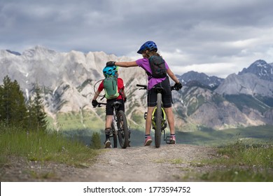 Kananaskis Country, Alberta Canada, July 8 2020: A Big Sister Is Comforting A Little Brother On A Family Mountain Bike Ride Following The Closure Of The Barrier Lake Information Centre.