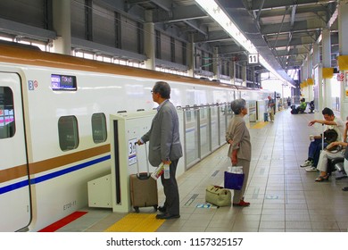 KANAZAWA, JAPAN - June 8, 2018. Business People Are Waiting At Entrance Door Of Hokuriko Shinkansen, High Speed Bullet Train With Connection To Tokyo At Railway Station Platform. Eco Friendly Maglev.