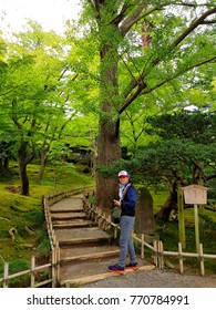 Kanazawa, Japan - September 29,2017: A Middle Aged Asian Man Steps Up And Keeps Walking Around The Greenery Garden In Kanazawa City Of Japan To Take A Deep Breath Of Nice View In Late Summer Of Japan.