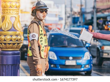 KANCHANABURI, THAILAND - APRIL 17,2019: Unidentified An employees of the traffic road police in uniforms serve on the road on Songkran festival on April 17, 2019 in Kanchanaburi, Thailand