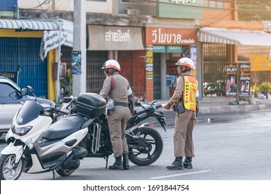 KANCHANABURI, THAILAND - APRIL 17,2019: Unidentified two employees of the traffic road police in uniforms with police motorcycles serve on the city street with transport on Songkran festival