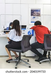 KANCHANABURI, THAILAND - AUGUST 27, 2020 : Unidentified Asian  Female Customer  Transact With Bank Staff During Coronavirus (Covid-19) Pandemic At TMB Bank Public Company Limited.New Normal Lifestyle.