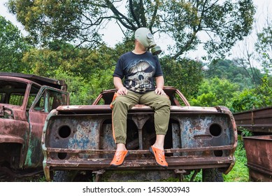 Kanchanaburi, Thailand - June, 30, 2019 : Unidentified Name Man In Gas Mask Is Visited Old Car Cemetery Of Tungsten Mining Ban E-Tong, Kanchanaburi, Thailand.