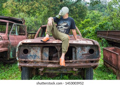 Kanchanaburi, Thailand - June, 30, 2019 : Unidentified Name Man In Gas Mask Is Visited Old Car Cemetery Of Tungsten Mining Ban E-Tong, Kanchanaburi, Thailand.