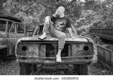 Kanchanaburi, Thailand - June, 30, 2019 : Unidentified Name Man In Gas Mask Is Visited Old Car Cemetery Of Tungsten Mining Ban E-Tong, Kanchanaburi, Thailand.