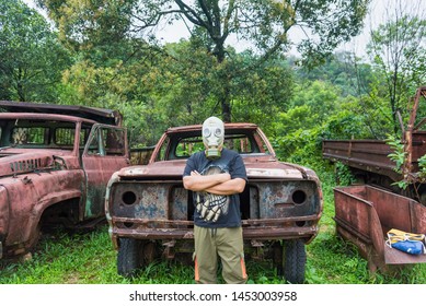 Kanchanaburi, Thailand - June, 30, 2019 : Unidentified Name Man In Gas Mask Is Visited Old Car Cemetery Of Tungsten Mining Ban E-Tong, Kanchanaburi, Thailand.