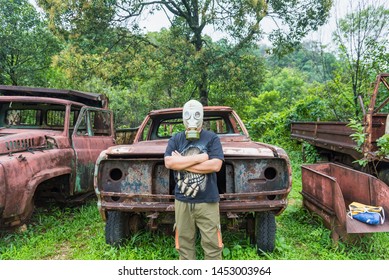 Kanchanaburi, Thailand - June, 30, 2019 : Unidentified Name Man In Gas Mask Is Visited Old Car Cemetery Of Tungsten Mining Ban E-Tong, Kanchanaburi, Thailand.