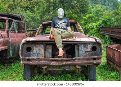 Kanchanaburi, Thailand - June, 30, 2019 : Unidentified Name Man In Gas Mask Is Visited Old Car Cemetery Of Tungsten Mining Ban E-Tong, Kanchanaburi, Thailand.