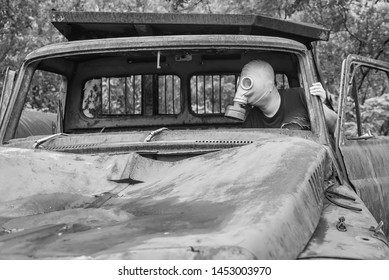 Kanchanaburi, Thailand - June, 30, 2019 : Unidentified Name Man In Gas Mask Is Visited Old Car Cemetery Of Tungsten Mining Ban E-Tong, Kanchanaburi, Thailand.