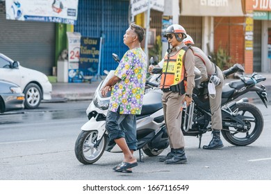KANCHANABURI, THAILAND-APRIL 17,2019: Unidentified two employees of the traffic road police in uniforms with police motorcycles serve on the city street on the road with transport on Songkran festival