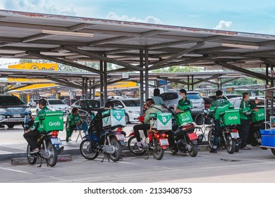 KANCHANABURI, THAILAND-AUGUST 22,2021 : Group Of Food Delivery Service Riders Park Motorbike To Relax And Wait To Get Food From The Restaurant At Parking Lot In Front Of Robinson Department Store.