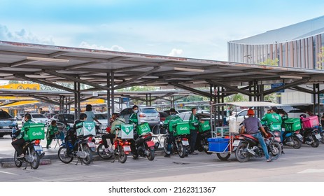 KANCHANABURI, THAILAND-AUGUST 22,2021 : Group Of Food Delivery Service Riders Park Motorbike To Relax And Wait To Get Food From The Restaurant At Parking Lot In Front Of Robinson Department Store.