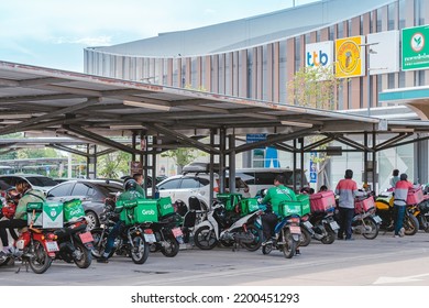 KANCHANABURI, THAILAND-AUGUST 22,2021 : Group Of Food Delivery Service Riders Park Motorbike To Relax And Wait To Get Food From The Restaurant At Parking Lot In Front Of Robinson Department Store.