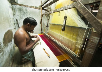 KANCHIPURAM, INDIA - 18 AUGUST 2010 : unidentified man weaving silk sari on loom. Kanchipuram is famous for hand woven silk sarees and most of the city's workforce is involved in weaving industry.