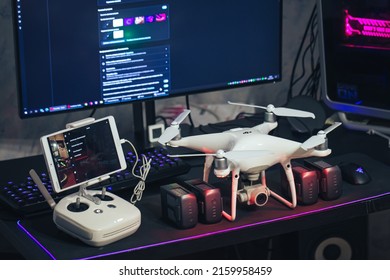 Kandalaksha, Russia - May 20, 2022: DJI Phantom 4 Pro V2.0 Quadcopter Drone with Batteries and Controller on the Computer Table