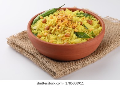 Kande Pohay OR Aloo Poha is a popular Indian breakfast recipe made using Flattened rice, usually served with hot tea. Selective focus - Powered by Shutterstock