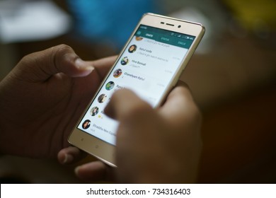 KANDIVALI, MUMBAI, MAHARASHTRA, INDIA - OCTOBER 10, 2017- A guy is using "WhatsApp" application on his cell phone at home in Mumbai, India.