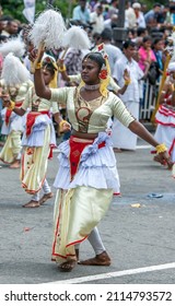 KANDY, SRI LANKA - AUGUST 11, 2014 : A female performer dances along Sri Dalada Veediya during the Day Perahera at Kandy in Sri Lanka.