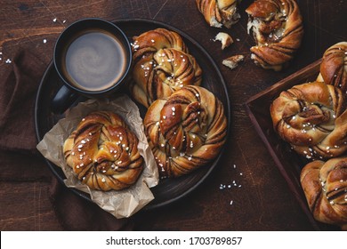 Kanelbullar, swedish cinnamon and cardamon buns, wooden background, top view