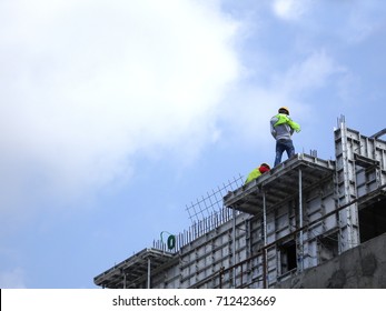 KANGAR, MALAYSIA -JULY 31, 2017: Construction Workers Working At Height Without Wearing Proper Safety Gear Like Body Harness. This Dangerous Act Can Cause Accidents And Death.