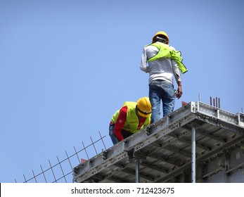 KANGAR, MALAYSIA -JULY 31, 2017: Construction Workers Working At Height Without Wearing Proper Safety Gear Like Body Harness. This Dangerous Act Can Cause Accidents And Death.