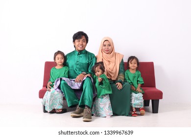 KANGAR, PERLIS, MALAYSIA,15th MARCH 2019: Asian Muslim Family Enjoying Quality Time Together With Traditional Clothes Celebrating Eid Mubarakon White Studio. Malay Family During Hari Raya Aidilfitri