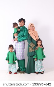 KANGAR, PERLIS, MALAYSIA,15th MARCH 2019: Asian Muslim Family Enjoying Quality Time Together With Traditional Clothes Celebrating Eid Mubarakon White Studio. Malay Family During Hari Raya Aidilfitri