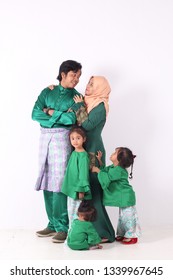 KANGAR, PERLIS, MALAYSIA,15th MARCH 2019: Asian Muslim Family Enjoying Quality Time Together With Traditional Clothes Celebrating Eid Mubarakon White Studio. Malay Family During Hari Raya Aidilfitri