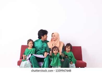 KANGAR, PERLIS, MALAYSIA,15th MARCH 2019: Asian Muslim Family Enjoying Quality Time Together With Traditional Clothes Celebrating Eid Mubarakon White Studio. Malay Family During Hari Raya Aidilfitri