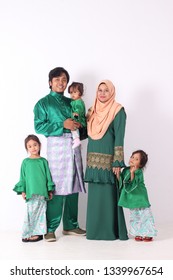 KANGAR, PERLIS, MALAYSIA,15th MARCH 2019: Asian Muslim Family Enjoying Quality Time Together With Traditional Clothes Celebrating Eid Mubarakon White Studio. Malay Family During Hari Raya Aidilfitri