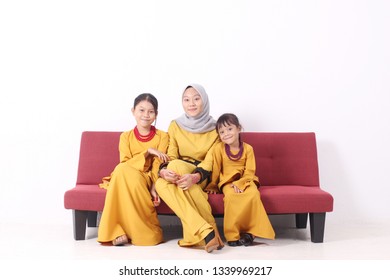 KANGAR, PERLIS, MALAYSIA,15th MARCH 2019: Asian Muslim Family Enjoying Quality Time Together With Traditional Clothes Celebrating Eid Mubarak On White Studio. Malay Family During Hari Raya Aidilfitri